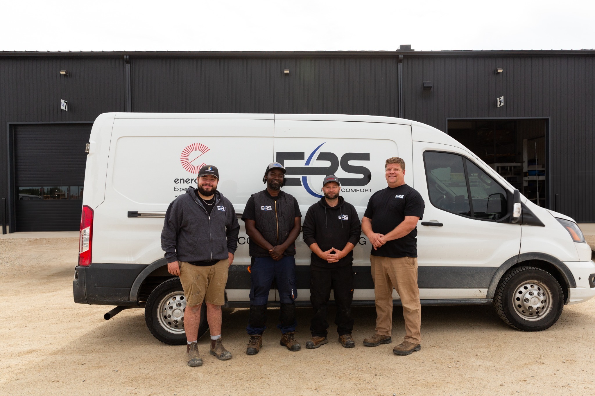 The ERS Home Comfort service team standing beside their ERS van